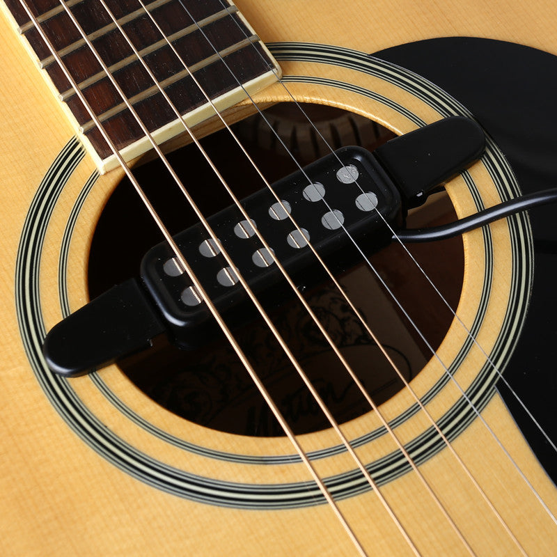 Black acoustic guitar soundhole pickup mounted with connecting cable
