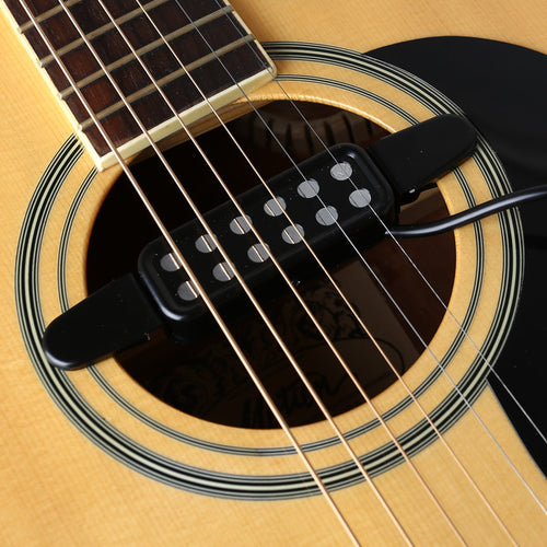 Black acoustic guitar soundhole pickup mounted with connecting cable